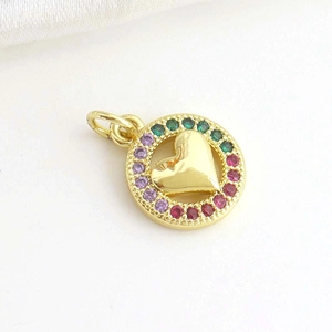 Macro shot of 18k gold plated heart pendant with colorful crystals and polished center