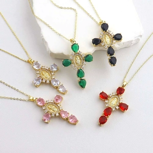 Elegant adjustable gold cross necklaces featuring teardrop gemstones and religious relief