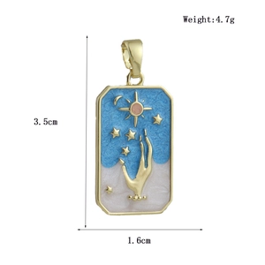 Detail view of 4.7g celestial tarot pendant with sun and moon enamel gold finish
