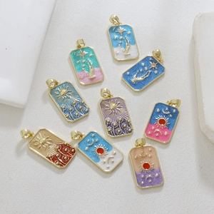 Detail of tarot card charms with sun and moon patterns in gold-plated enamel finish