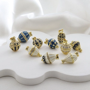 Detailed macro view of Fabergé style egg and balloon pendants with enamel and crystals