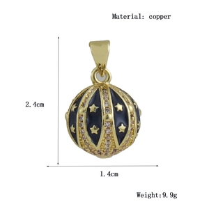 Detail of copper egg pendant featuring blue enamel stars and crystal inlay