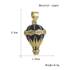 Detail view of gold-plated copper hot air balloon pendant with blue enamel and zircons