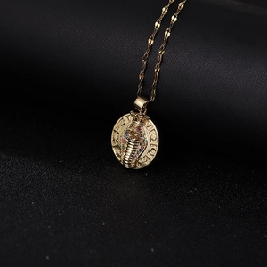 Vintage cobra pendant necklace with multicolored gems on a round gold-plated medallion