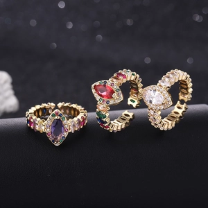 Macro shot of adjustable vintage gold rings with marquise cut zircon in multiple colors