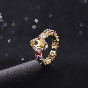 Detail of gold-plated ring with marquise yellow zircon and colorful gemstones