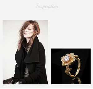 Detailed view of a gold-plated flower ring with a cubic zirconia center and micro-pave petals