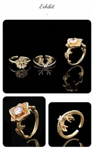 Detailed view of three gold-plated adjustable rings with zircons and floral motifs