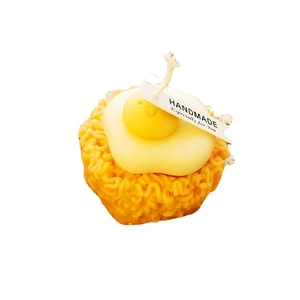 Creative instant noodle and egg candle with handmade tag on white background