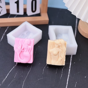 Detailed view of silicone molds featuring 3D mermaid and female body relief carvings