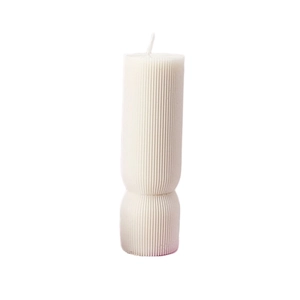 Minimalist white ribbed pillar candle with vertical texture and stylish geometric waist