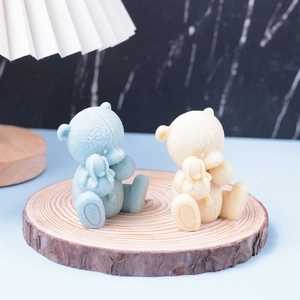 3D bear candle mold set featuring blue and yellow bears holding small rabbits