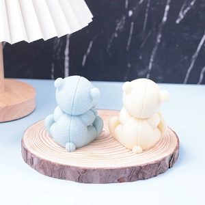 Detailed view of light blue and beige teddy bear storage boxes on a rustic wooden base