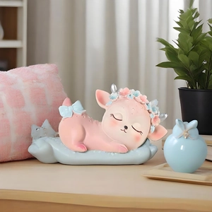 Pink cartoon sleeping deer resin ornament with flower garland on a blue wave base