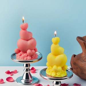 Three-layer heart scented candle with rose base on silver tray for home decor