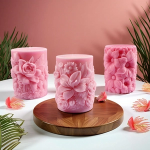 Three pink cylinder candle molds with 3D embossed flower carvings in a set