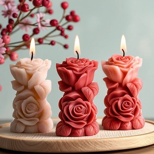 Artistic set of rose flower candles in pink and red on a wooden tray for gift decor