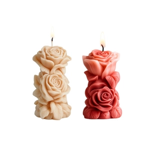 Elegant rose column scented candles with lifelike petals and burning flames on white background