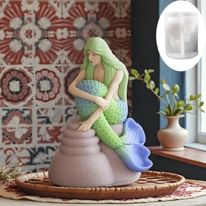 Mermaid silicone mold for DIY candles with colorful gradients on a woven tray