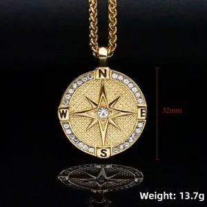 Detail of 32mm gold compass pendant with sparkling crystals and engraved cardinal points