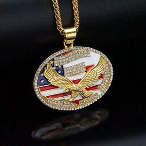 Hip hop style gold eagle pendant with American flag and crystals on black background