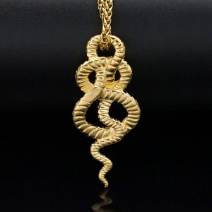 18k gold plated stainless steel snake pendant necklace with detailed scale texture on black