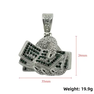 Iced out hip hop fist clutching dollar bills pendant with green stones and silver finish