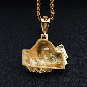 Detail of hip hop pendant back showing brushed gold texture and 3D craftsmanship