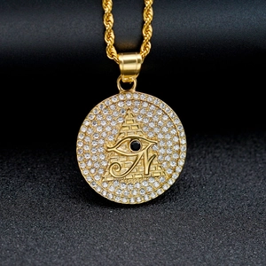 Golden Eye of Horus stainless steel pendant with black stone and white crystals