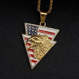 Macro detail of gold hip hop eagle pendant with US flag enamel and cubic zirconia stones