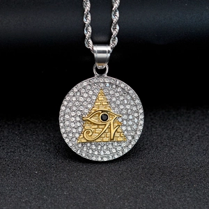 Macro detail of Eye of Horus pyramid pendant with silver rope chain and zircon stones