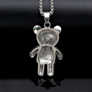 Rear view of silver hiphop bear pendant showing textured stainless steel back and chain