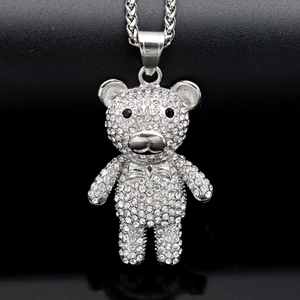 Macro shot of hiphop teddy bear pendant with sparkling crystals on black background