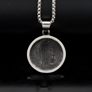 Polished silver stainless steel pendant necklace with unique fingerprint texture and box chain