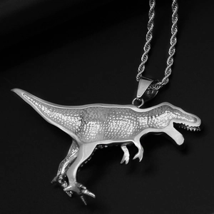 Macro close-up of textured silver dinosaur pendant on a braided rope chain necklace