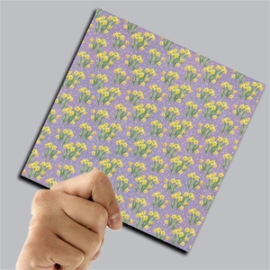 Detail of square vintage floral decorative paper held by hand for DIY journaling