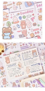 Detailed view of cartoon bear stickers and matching tape used in a creative journal spread