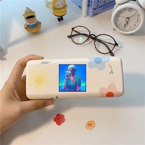 Floral matte power bank with color display screen in a minimalist aesthetic desktop setting
