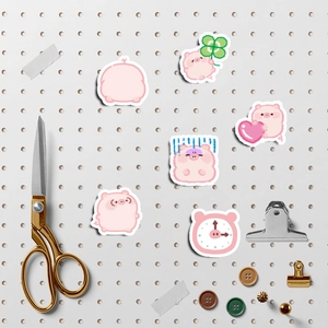 Set of cute pink pig cartoon stickers for suitcases and laptops on a pegboard decor