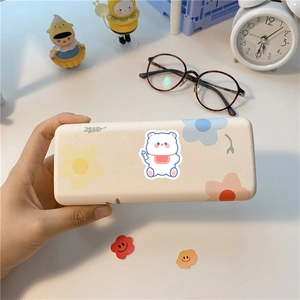 Detailed view of a cute bear floral stationery storage box held in hand for desk decor