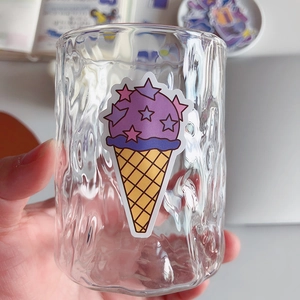 Hammered texture glass cup decorated with a cute purple ice cream sticker in hand