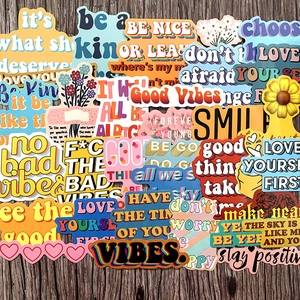 Waterproof inspirational quote stickers with floral designs on a dark wood background