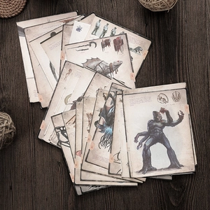 Macro view of retro Cthulhu monster illustration cards on a dark wood background