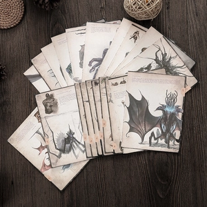 Macro view of Cthulhu monster illustration cards with index tabs on dark wood background