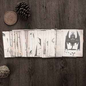 Macro shot of 50 vintage Cthulhu monster illustration papers on dark wood background