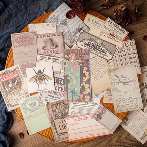 Vintage junk journal paper kit featuring botanical prints and retro music sheets on wood