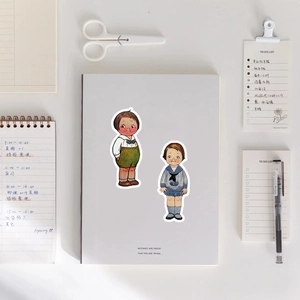 Retro vintage cartoon stickers on notebook with diy scrapbook tools flat lay view