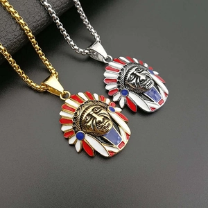 Close-up of gold and silver Indian chief pendants with red white and blue enamel feathers