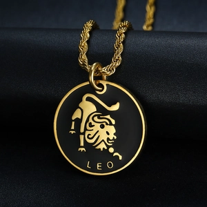Macro view of Leo zodiac coin pendant with black enamel and gold rope chain