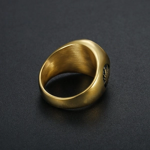 Gold stainless steel signet ring featuring a polished finish and engraved maple leaf detail